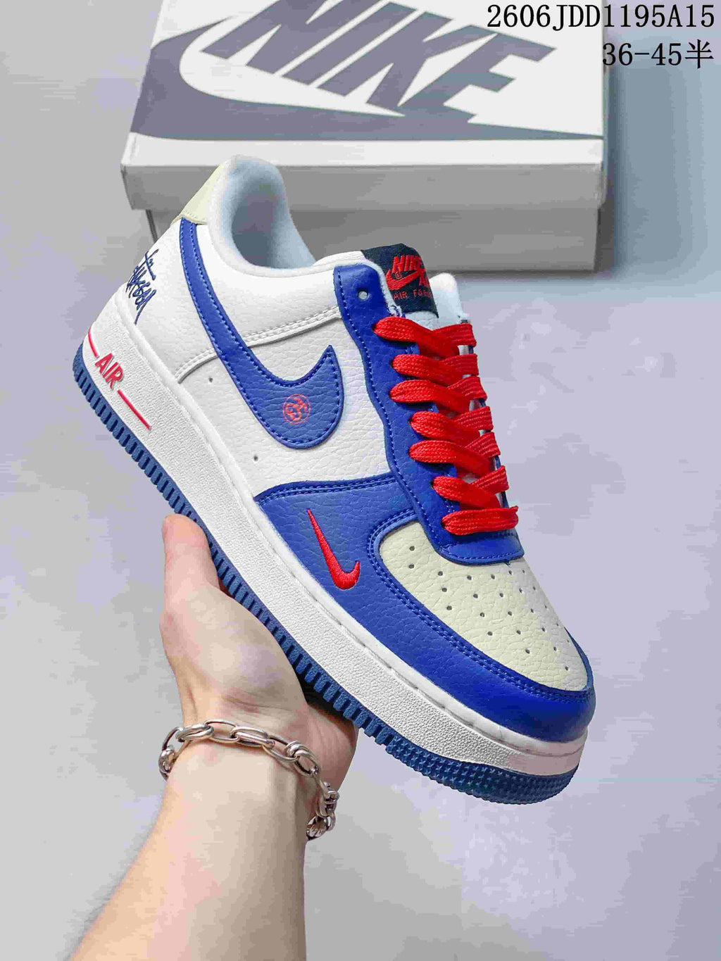 Angled side view of a white and blue Nike Air Force 1 Low with red laces