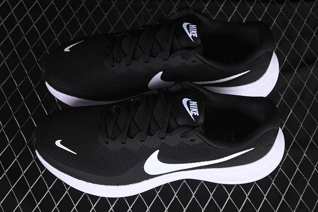 Pair of black and white Nike Revolution 8 shoes shown from above