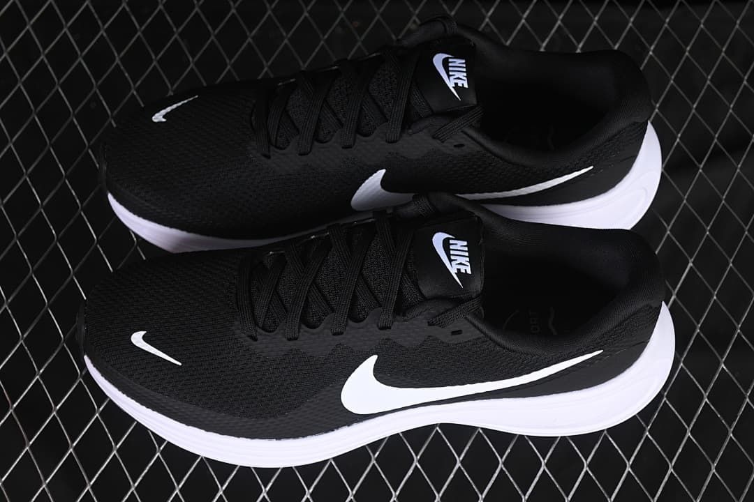 Pair of black and white Nike Revolution 8 shoes shown from above
