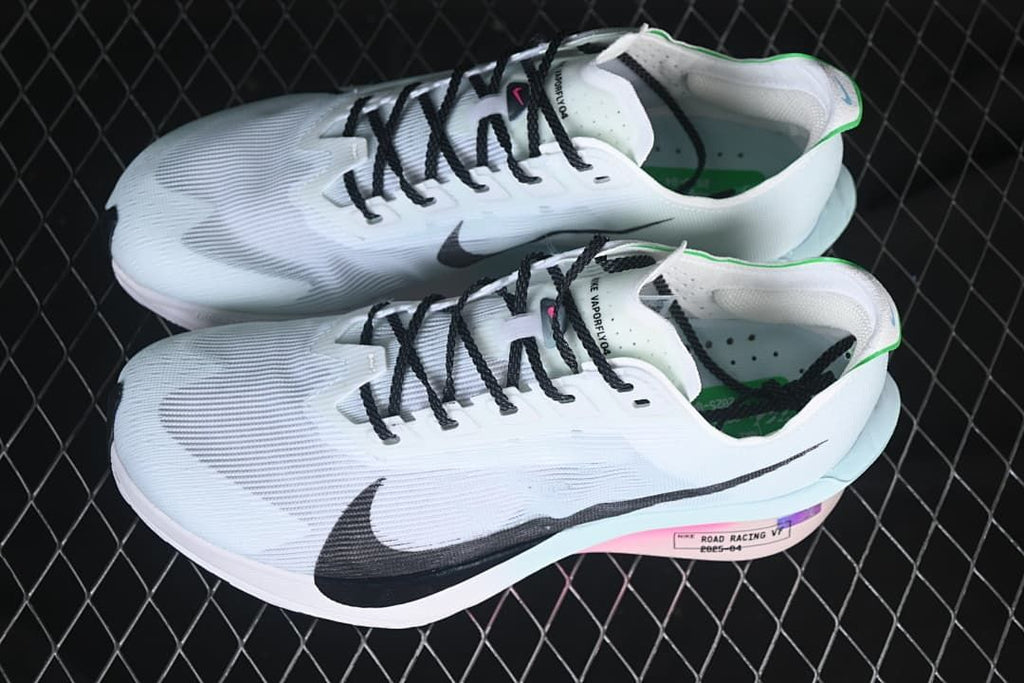 Pair of white Nike road-racing shoes with black laces and multicolor midsole details