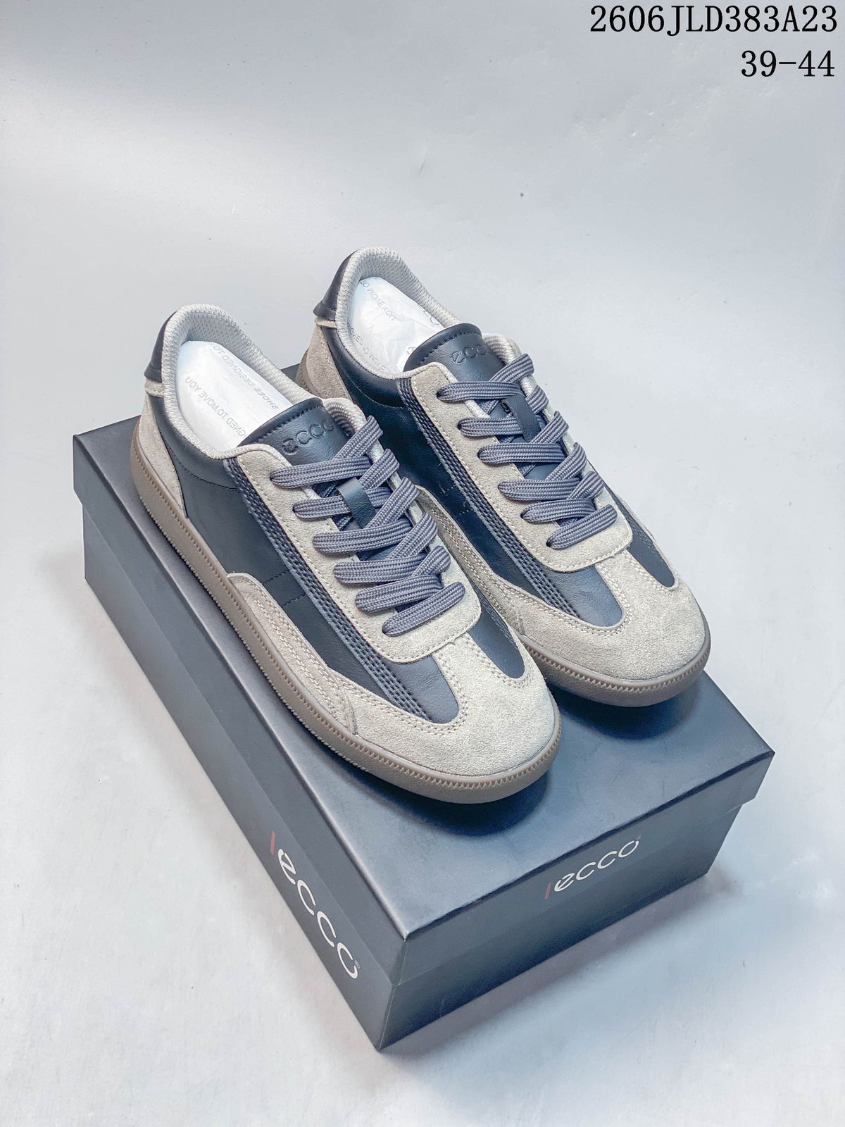 Pair of gray and navy ECCO low-top lace-up sneakers with contrasting panels