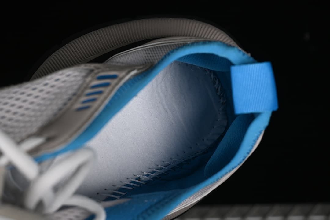 Close-up of the sneaker interior, blue lining, and heel pull tab