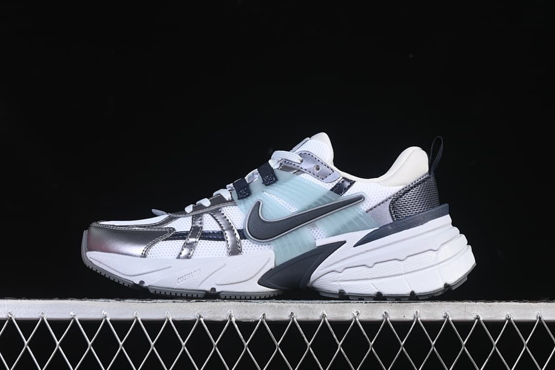 Side profile of the white, silver, and pale aqua Nike V2K Run sneaker.