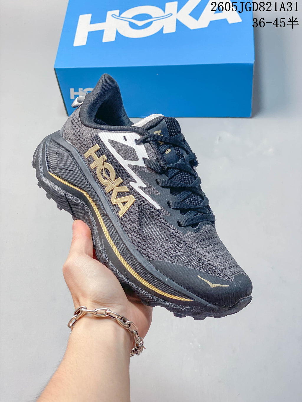 Dark gray HOKA Challenger 8 mesh running shoe with gold-colored accents