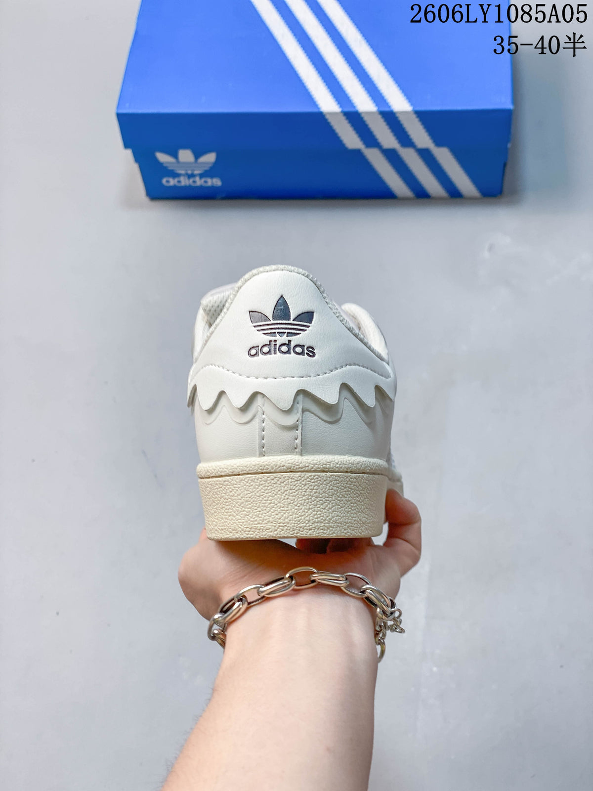 Rear view of a cream Adidas Superstar sneaker with trefoil branding