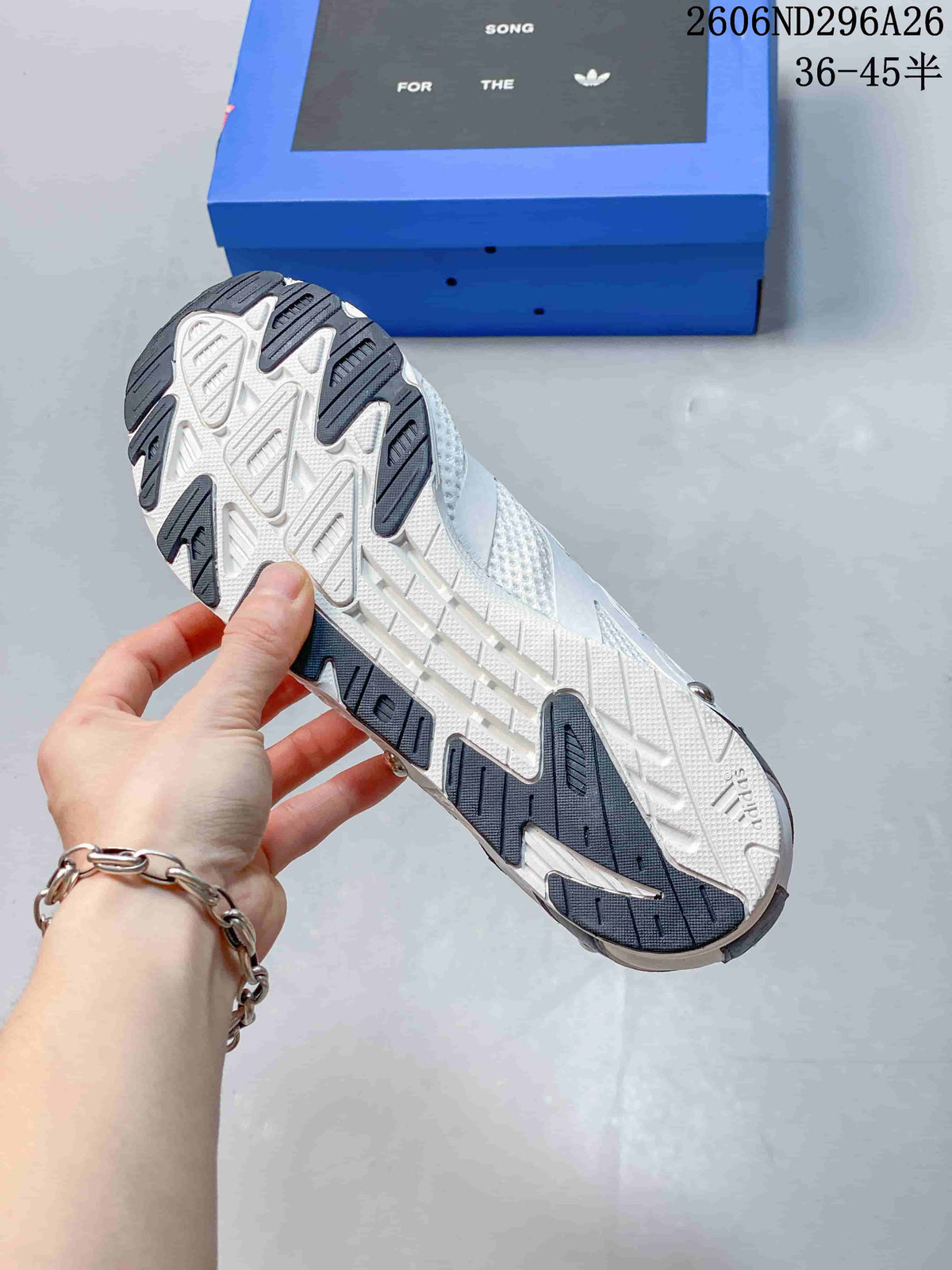 Outsole view of a white low-top sneaker with dark tread sections