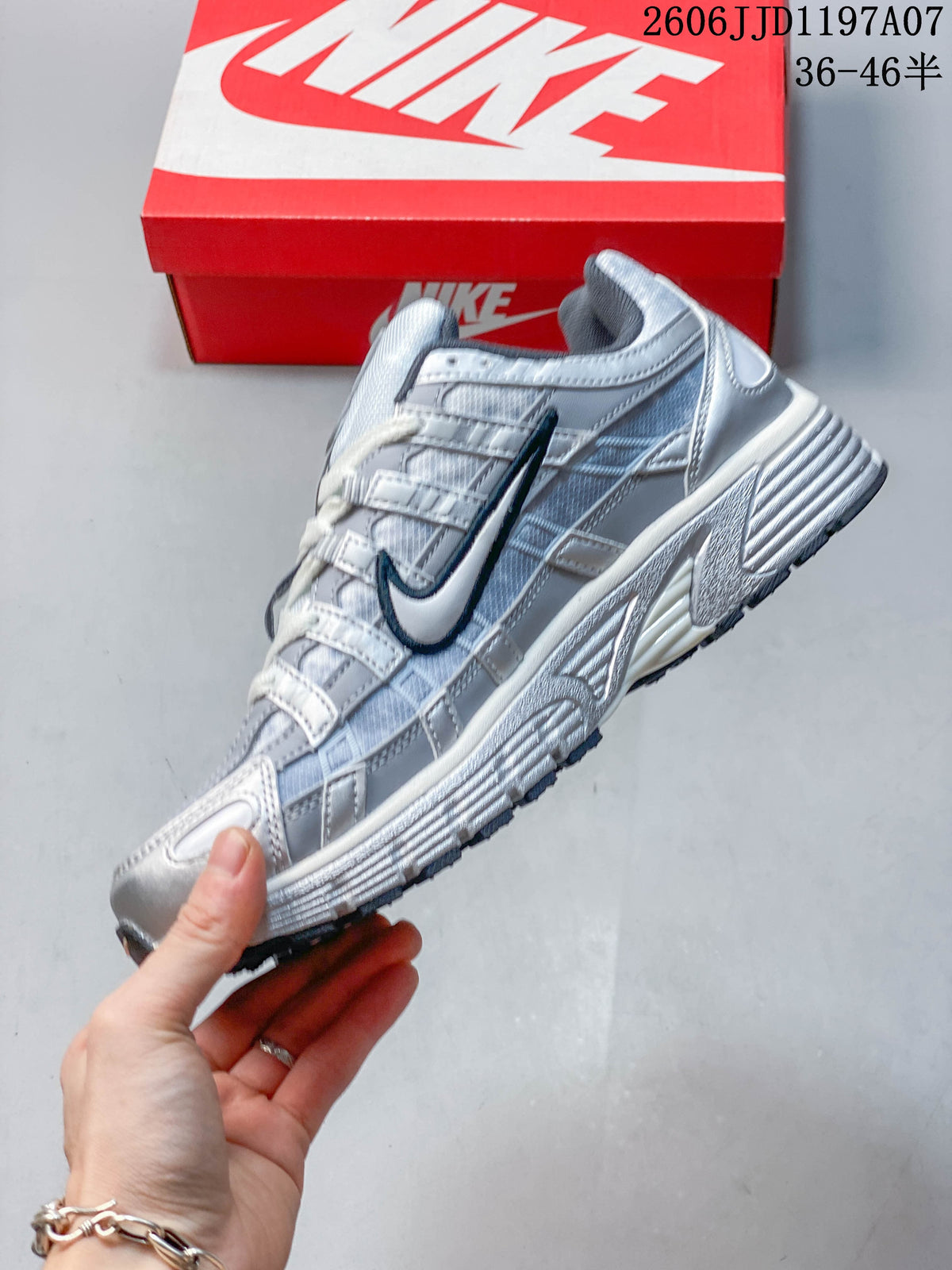 Side profile of a silver and light gray Nike P-6000 sneaker