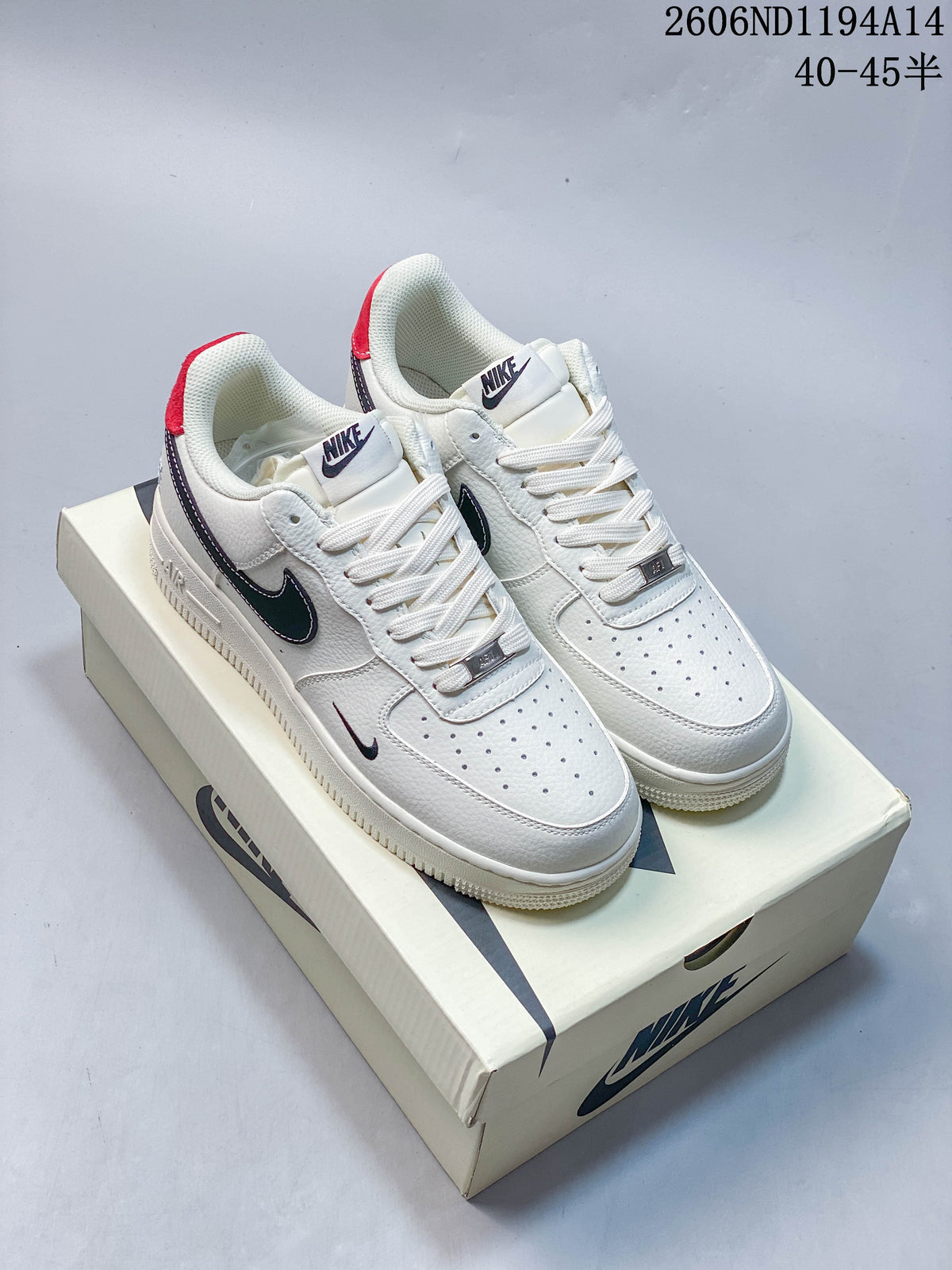 White Nike Air Force 1 '07 Low sneakers with dark contrasting accents, photographed on a shoebox.