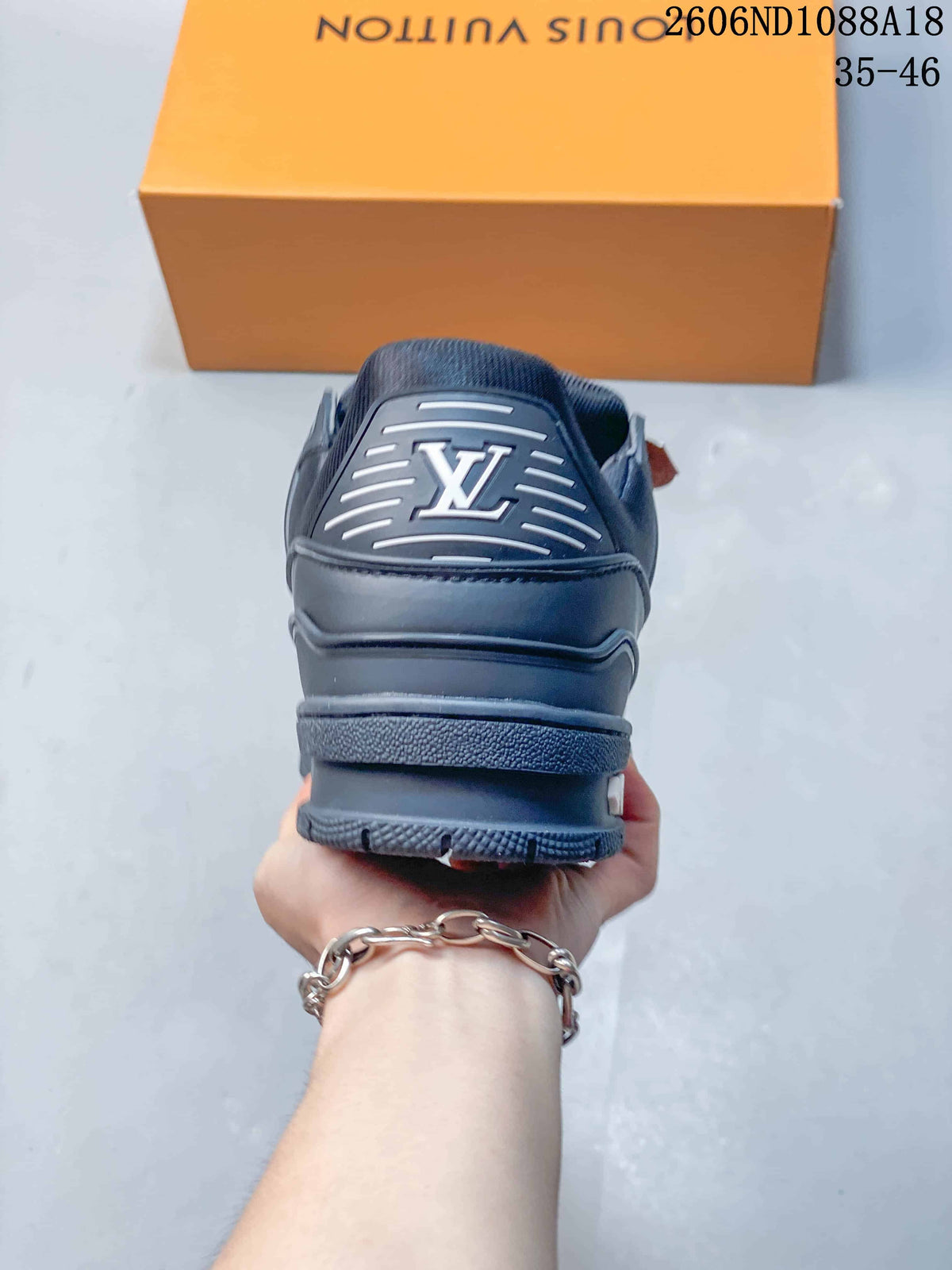 Rear view of a navy sneaker showing the heel logo and layered sole