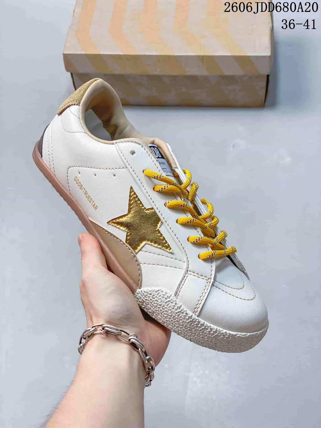 Side view highlighting the gold star, white upper, and gum-colored outsole