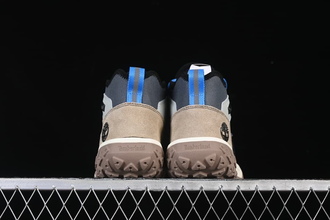 Rear view of both boots showing heel panels, pull loops, and outsoles