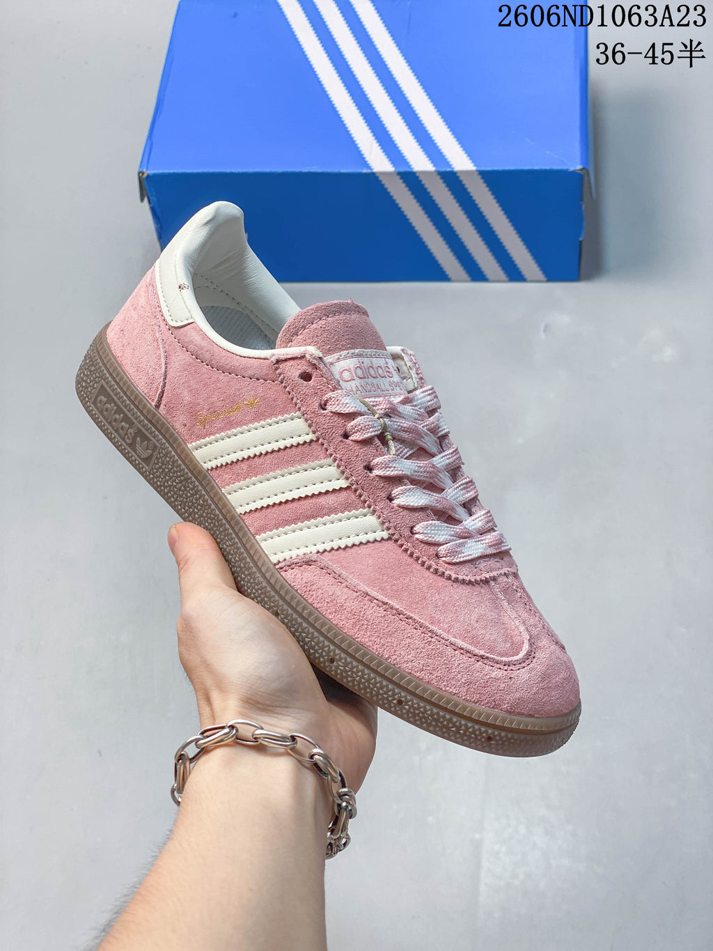 Pink Adidas Spezial low-top sneaker with light stripes and a dark gum-toned sole.