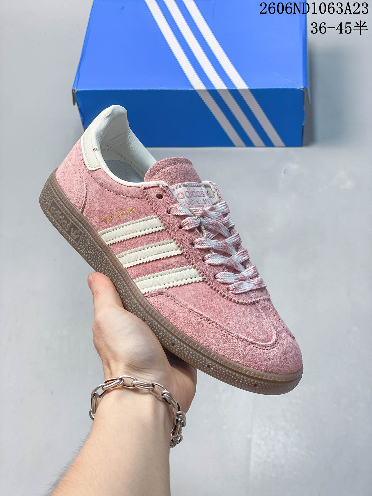 Pink Adidas Spezial low-top sneaker with light stripes and a dark gum-toned sole.