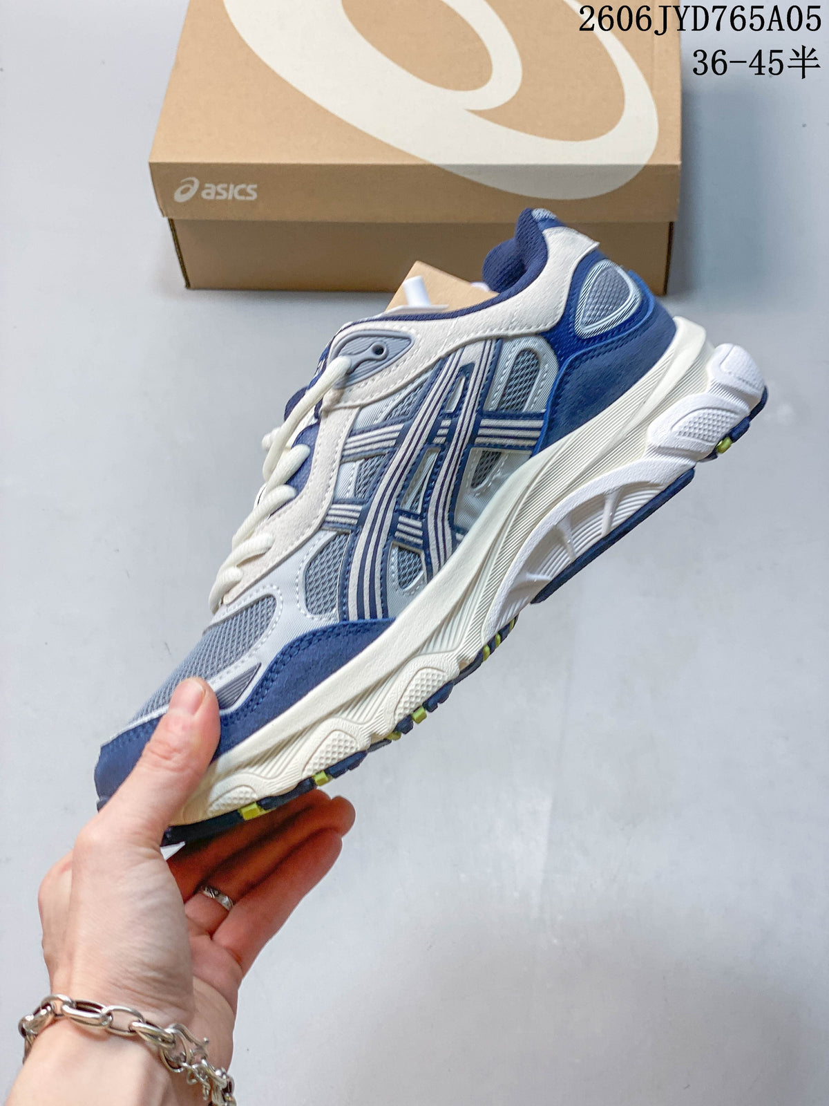 Side view of a blue and white sneaker with mesh panels and a sculpted sole.
