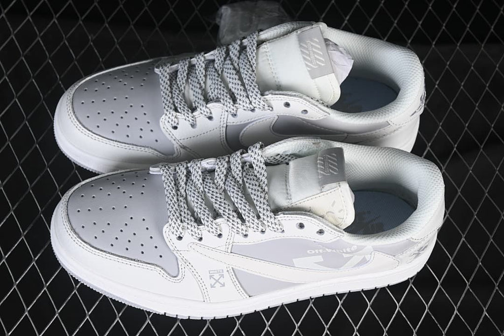 Pair of white and light grey low-top sneakers viewed from above, showing patterned laces and perforated toe panels