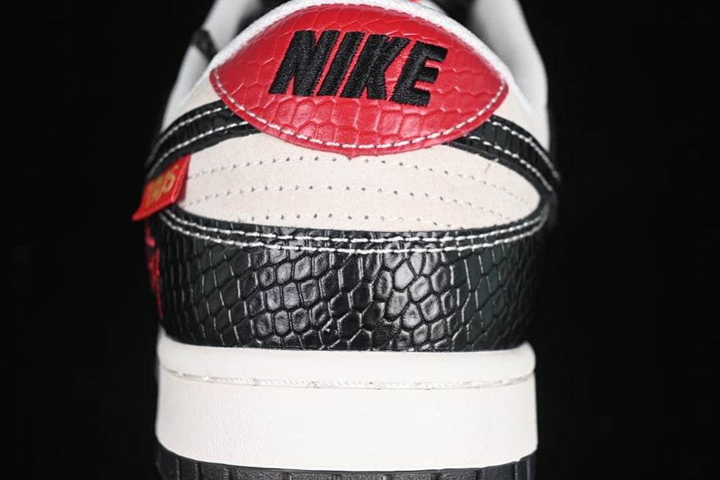 Rear view showing a red heel tab and black patterned panels