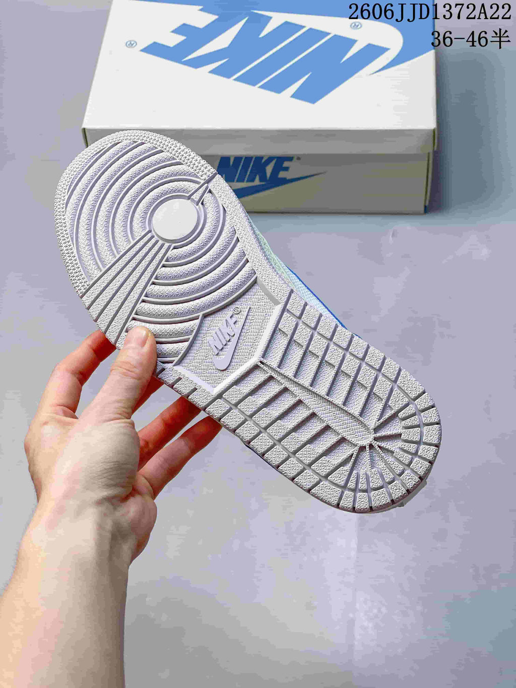 Close-up of the patterned outsole on a white sneaker