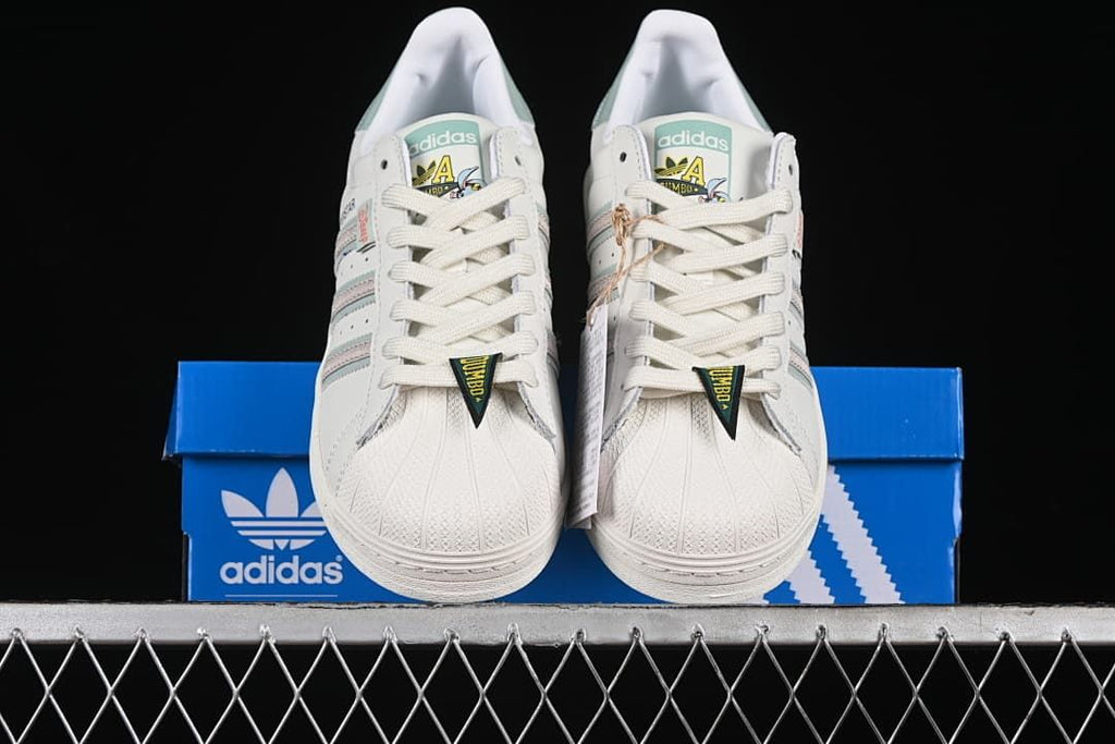 Front view of the pair showing shell toes, laces, and Dumbo-themed tongue details