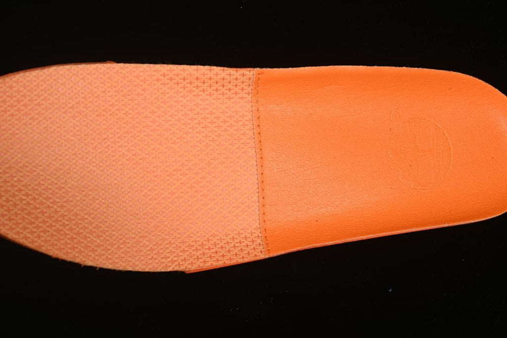 Close-up of the orange insole and textured footbed