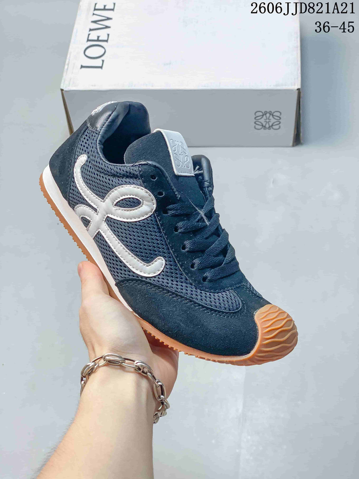 Side view of a navy mesh sneaker with white side detailing