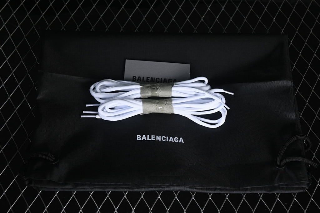 White spare laces arranged on a black branded drawstring bag.