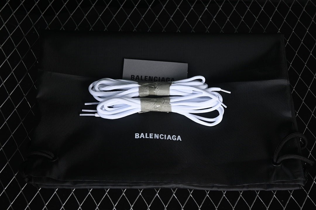 White spare laces arranged on a black branded drawstring bag.