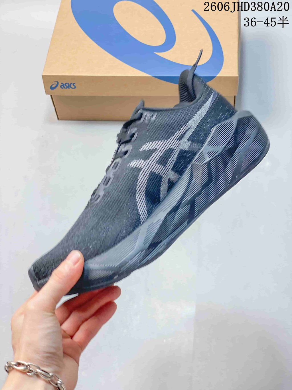 Side profile of the dark charcoal running shoe with patterned side details
