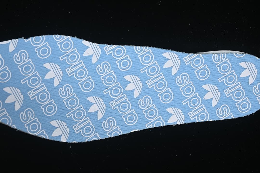 Blue insole fabric with repeating adidas Trefoil branding