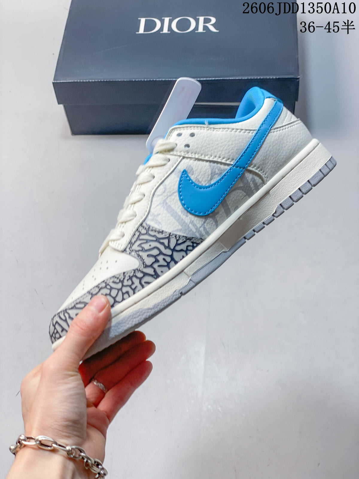 Side view of the white and blue low-top sneaker with gray patterned panels.