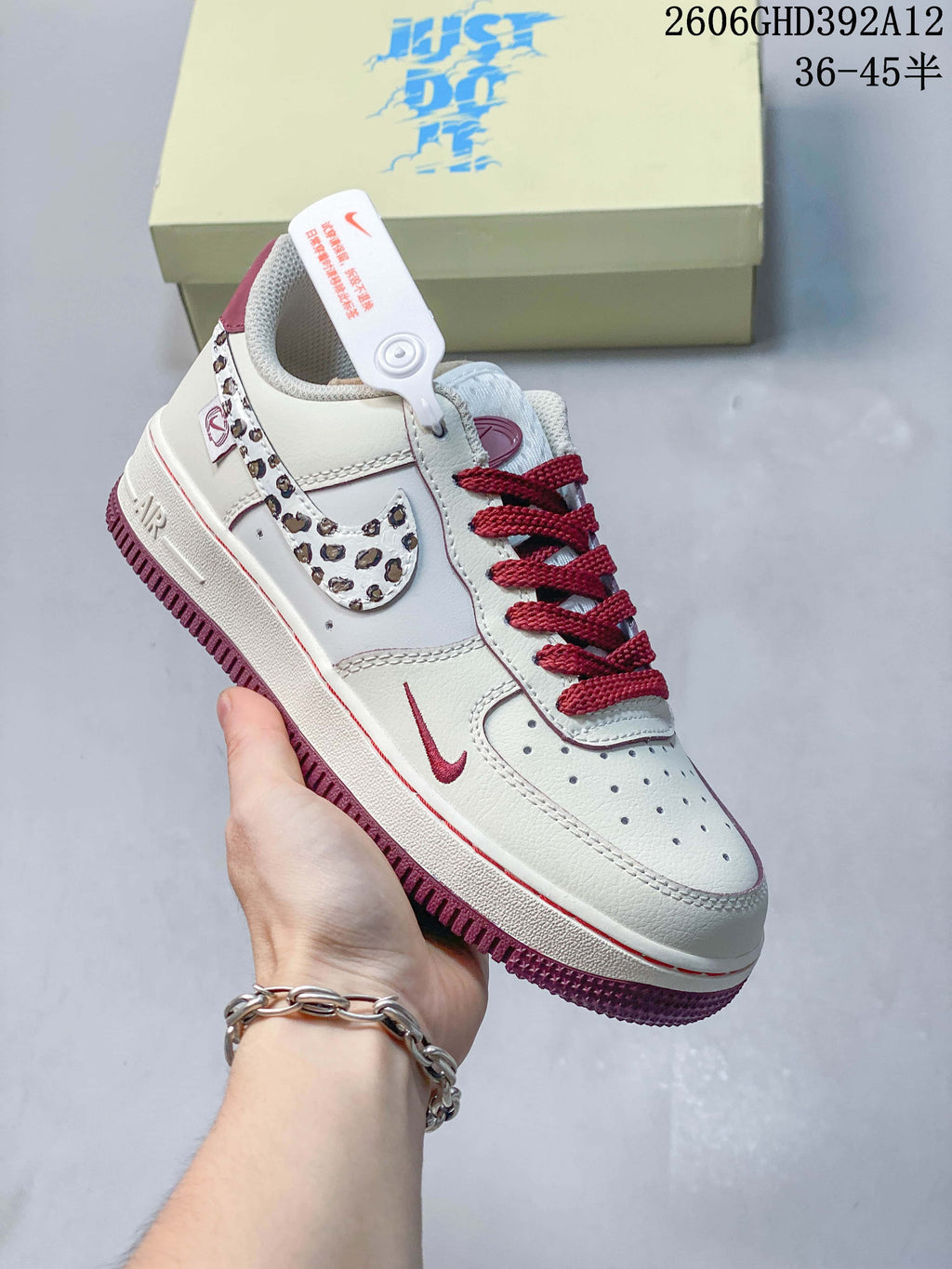 Angled side view highlighting leopard-print Swoosh panels and burgundy outsole