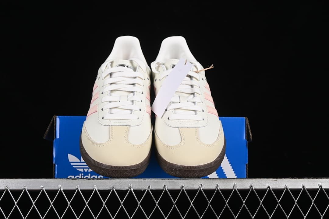 Front view of the pair displayed on a blue adidas shoe box