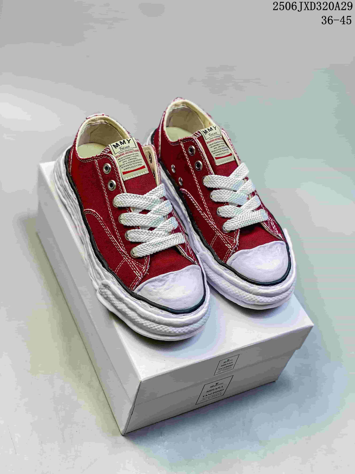 Pair of burgundy Maison Mihara Yasuhiro low-top sneakers with white laces and sculpted white soles