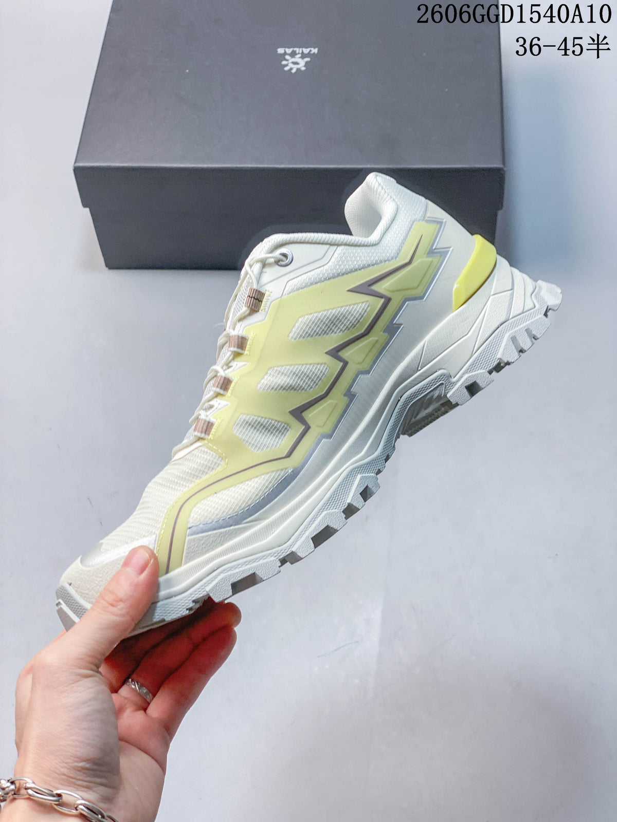 Side view of a KAILAS low-top hiking shoe with pale lime overlays and a lugged outsole.