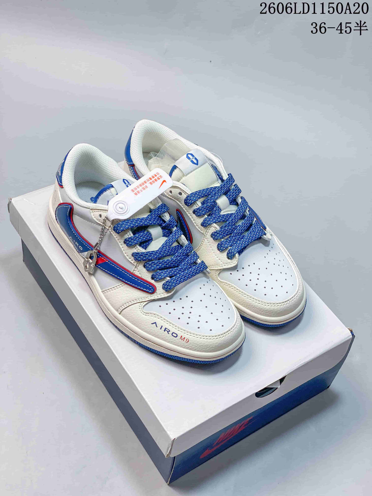 White low-top sneakers with blue and red accents, blue laces, and decorative side detailing.
