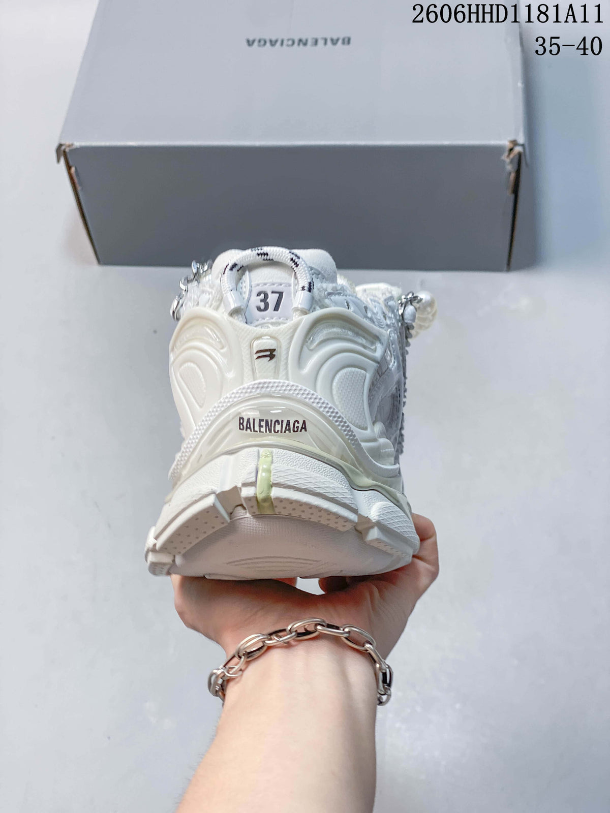Rear view of the white sneaker, showing the heel construction and branding.