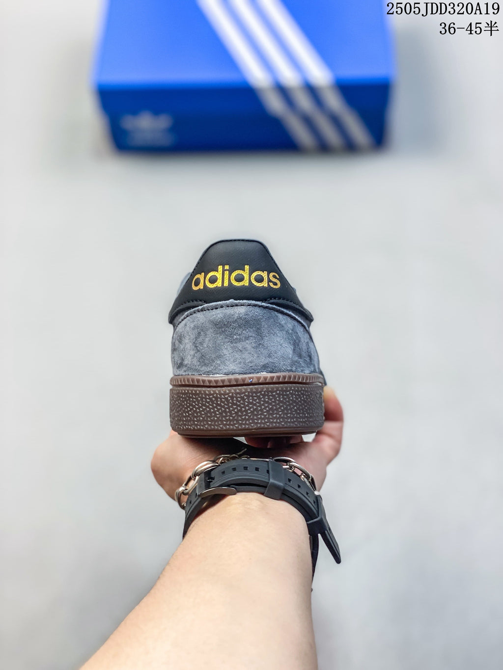 Rear view of the grey sneaker showing its heel tab and brown sole.