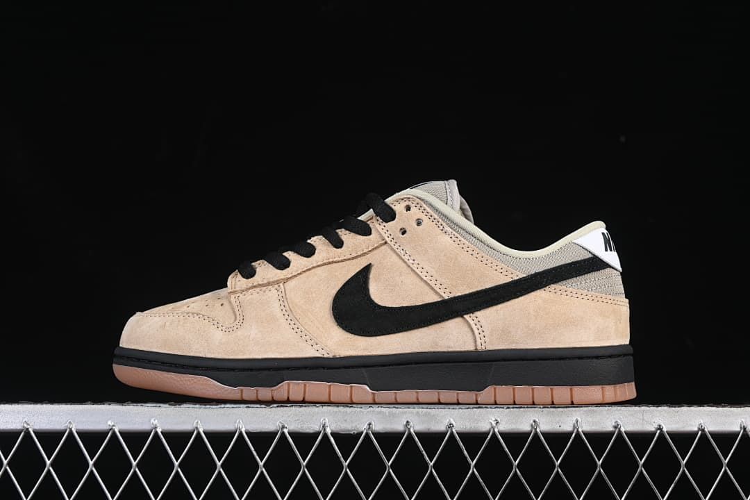 Side view of a beige and black Nike SB Dunk Low with a gum-colored outsole