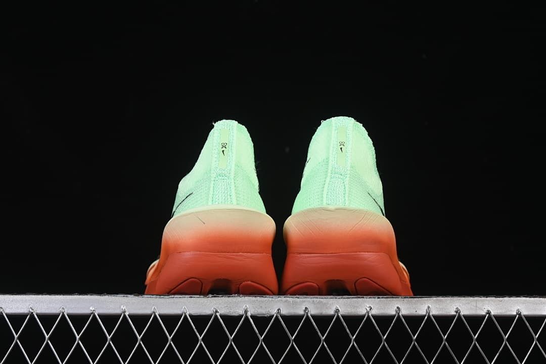 Rear view of the pair highlighting the coral-orange heel sections.