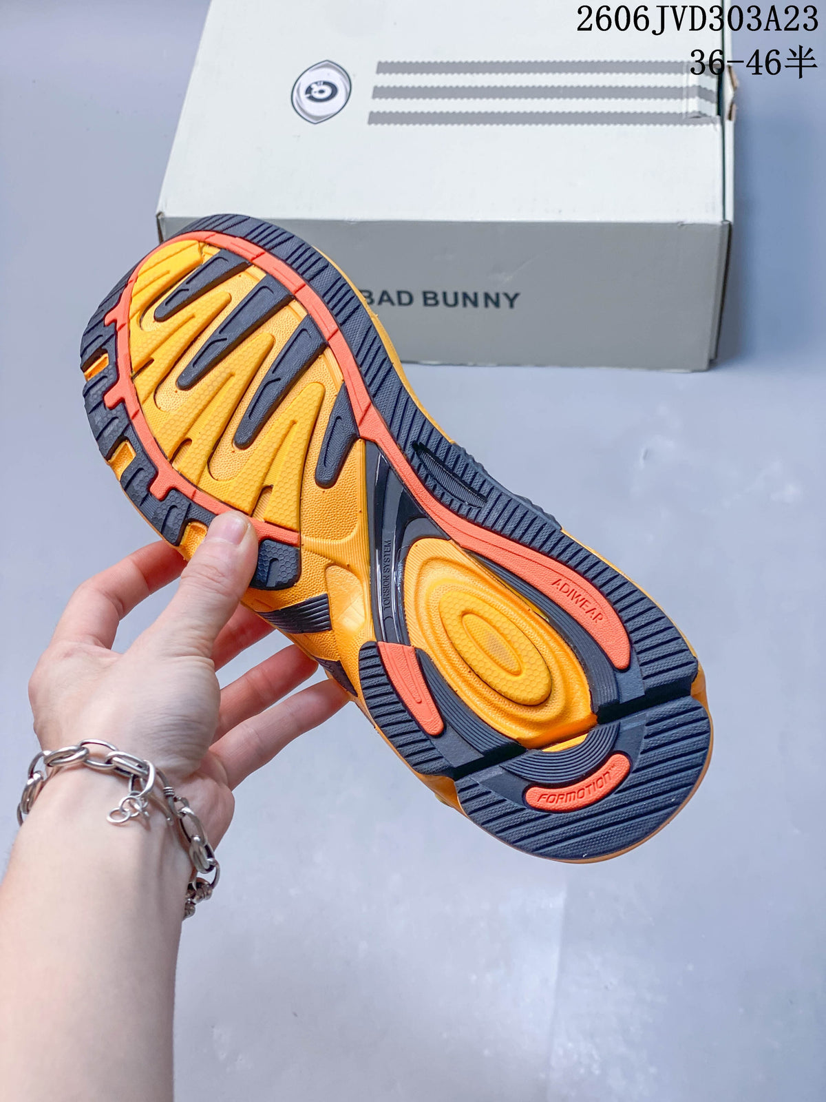 Close-up of the yellow and navy outsole with orange accents