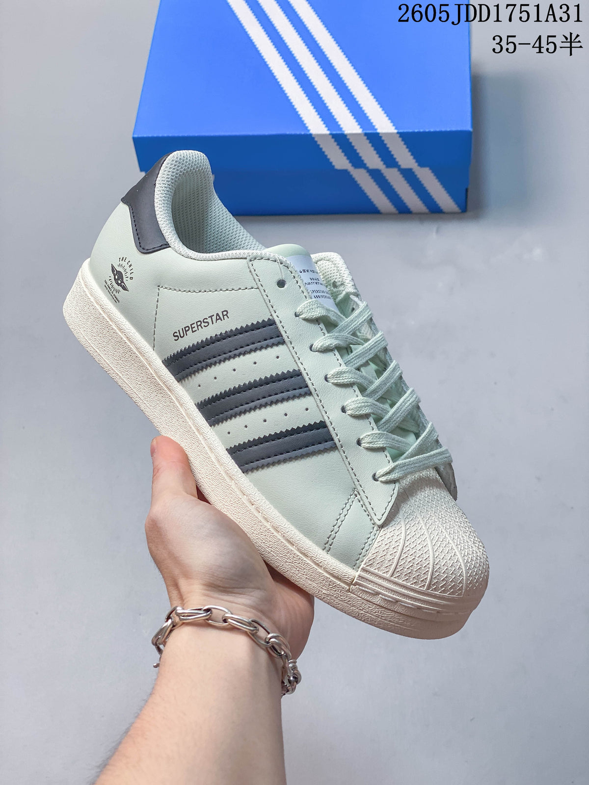 Pale mint sneaker with gray stripes and a white shell toe