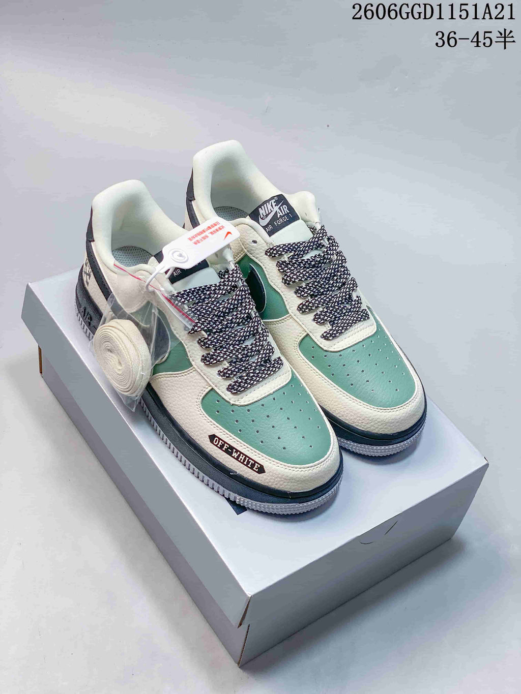 Pair of mint-green and off-white Air Force 1 style sneakers with patterned laces and a dark Swoosh