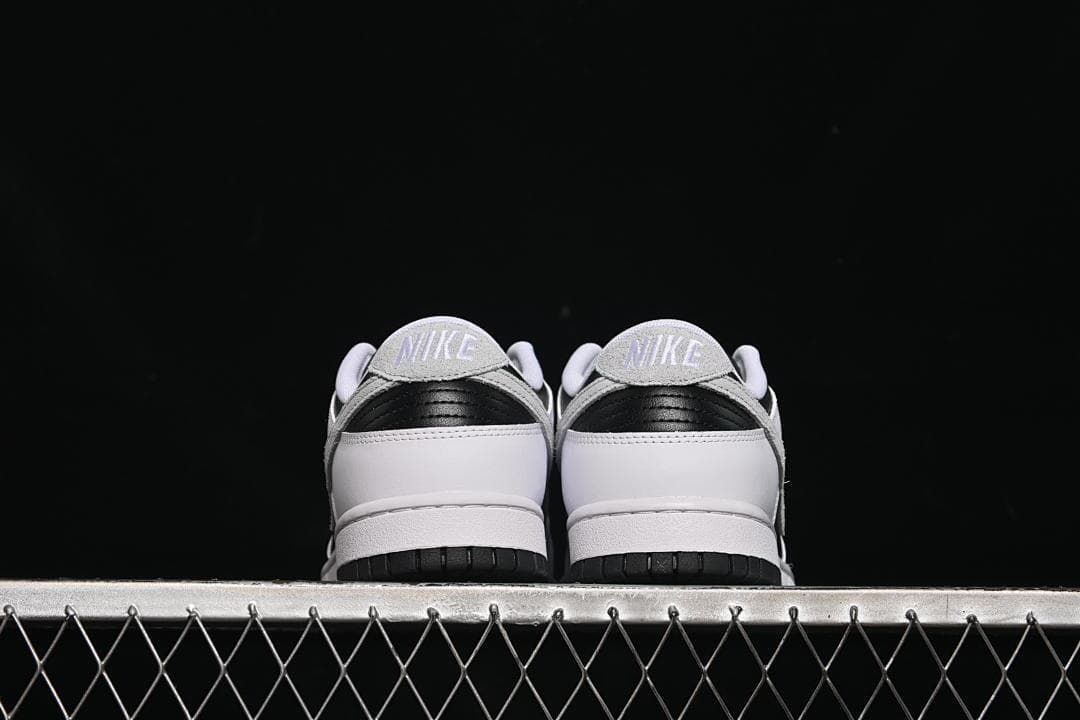 Rear view of both sneakers showing the heel panels and tabs