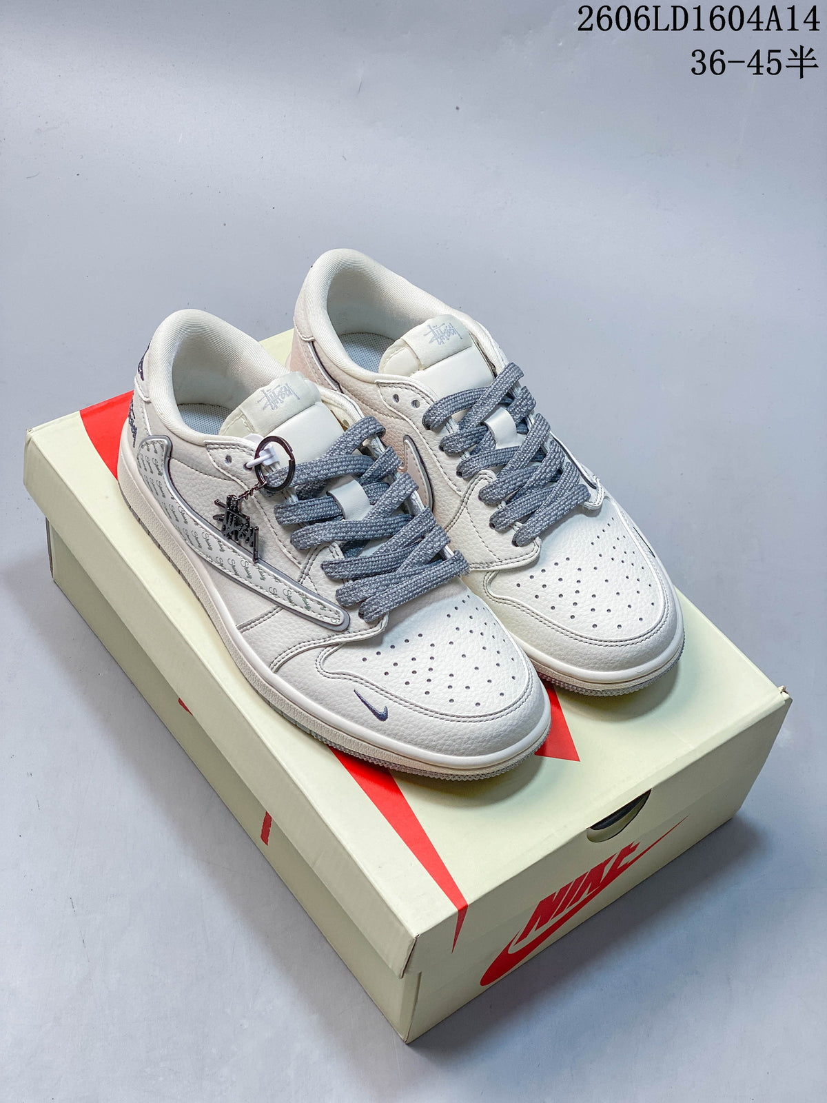 Pair of white low-top sneakers with gray laces and patterned side panels