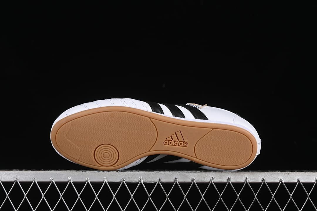 Underside view of the gum-colored outsole with patterned tread.