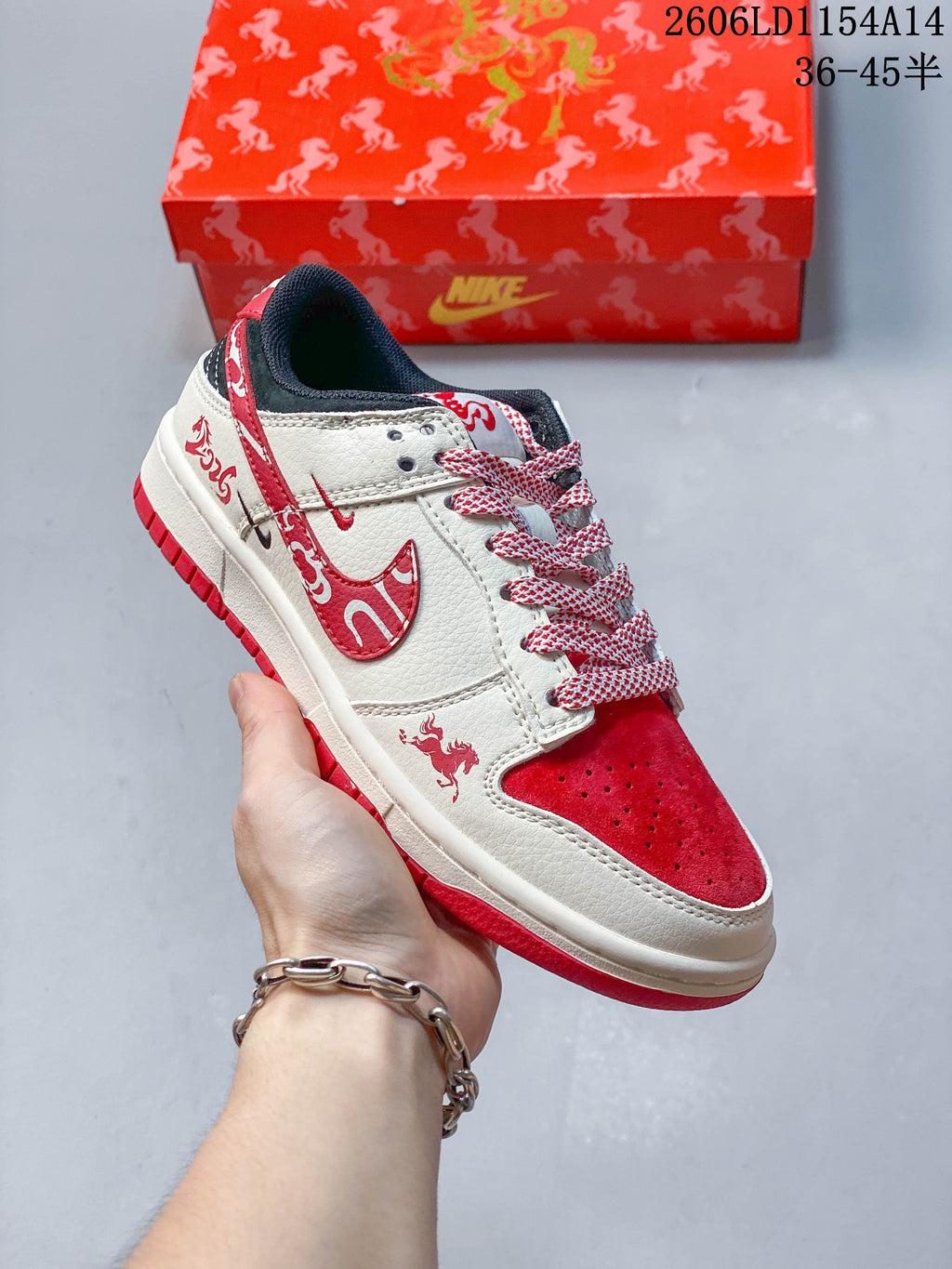 Angled side view of a cream and red low-top sneaker with patterned details