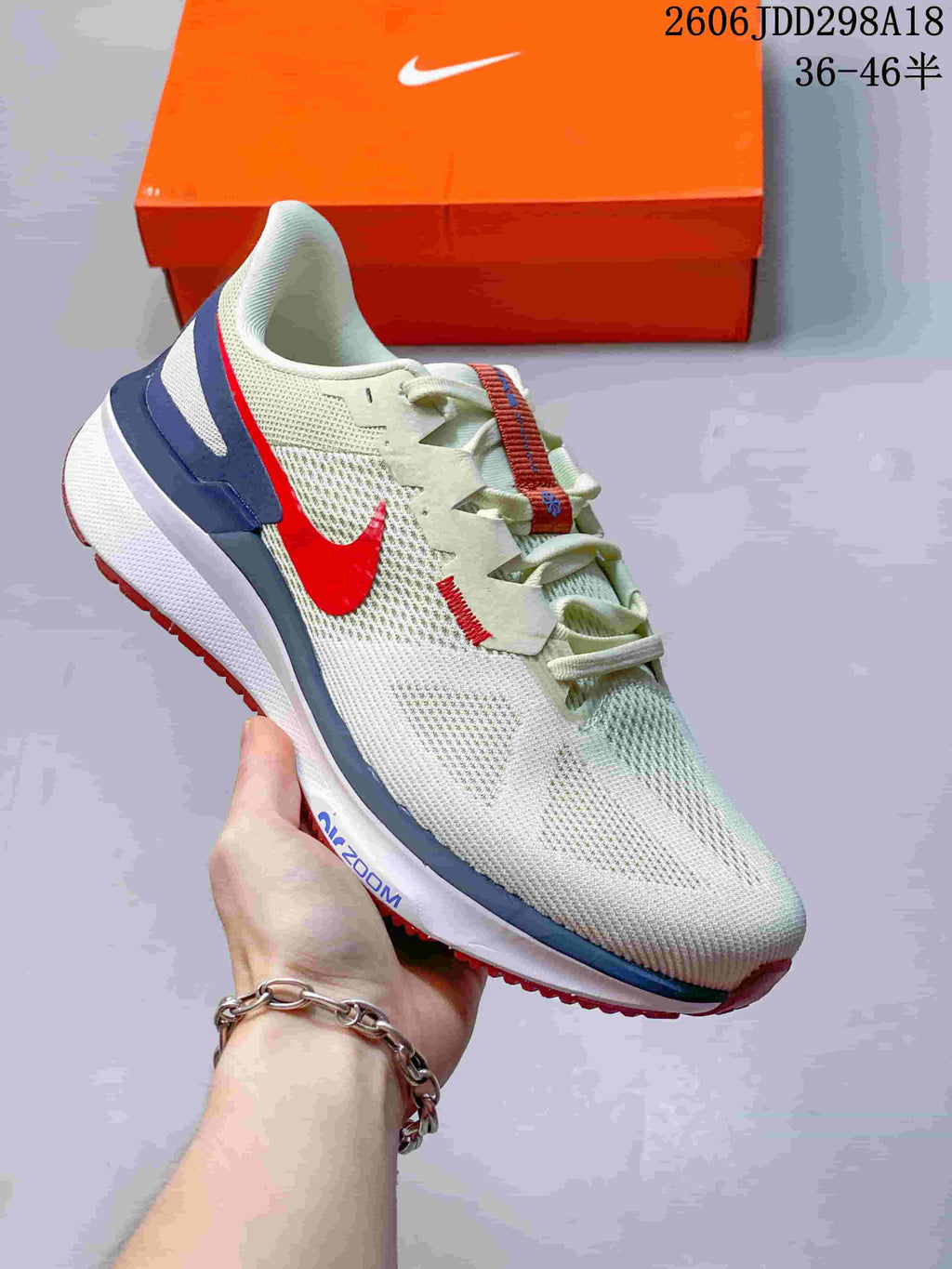 Side view of a white Nike running shoe with red and blue accents