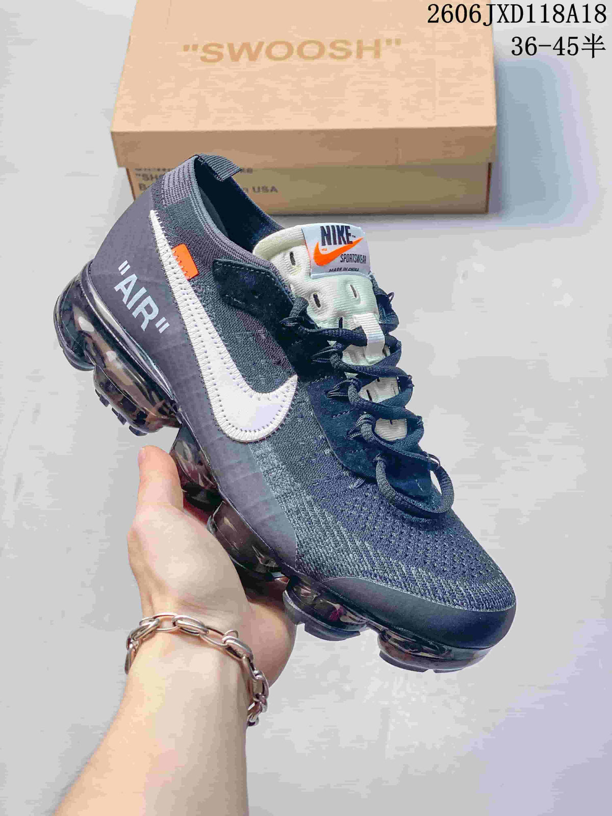 Dark gray low-top sneaker shown from the side with white Swoosh detail and transparent-looking sole.