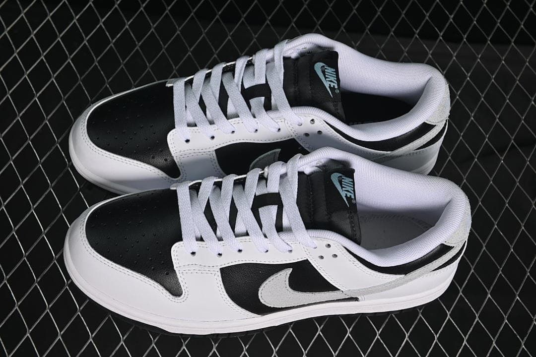 Pair of black, white, and grey low-top sneakers shown from above