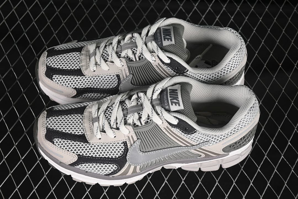 Pair of Nike Zoom Vomero 5 SP sneakers in grey, black and off-white.