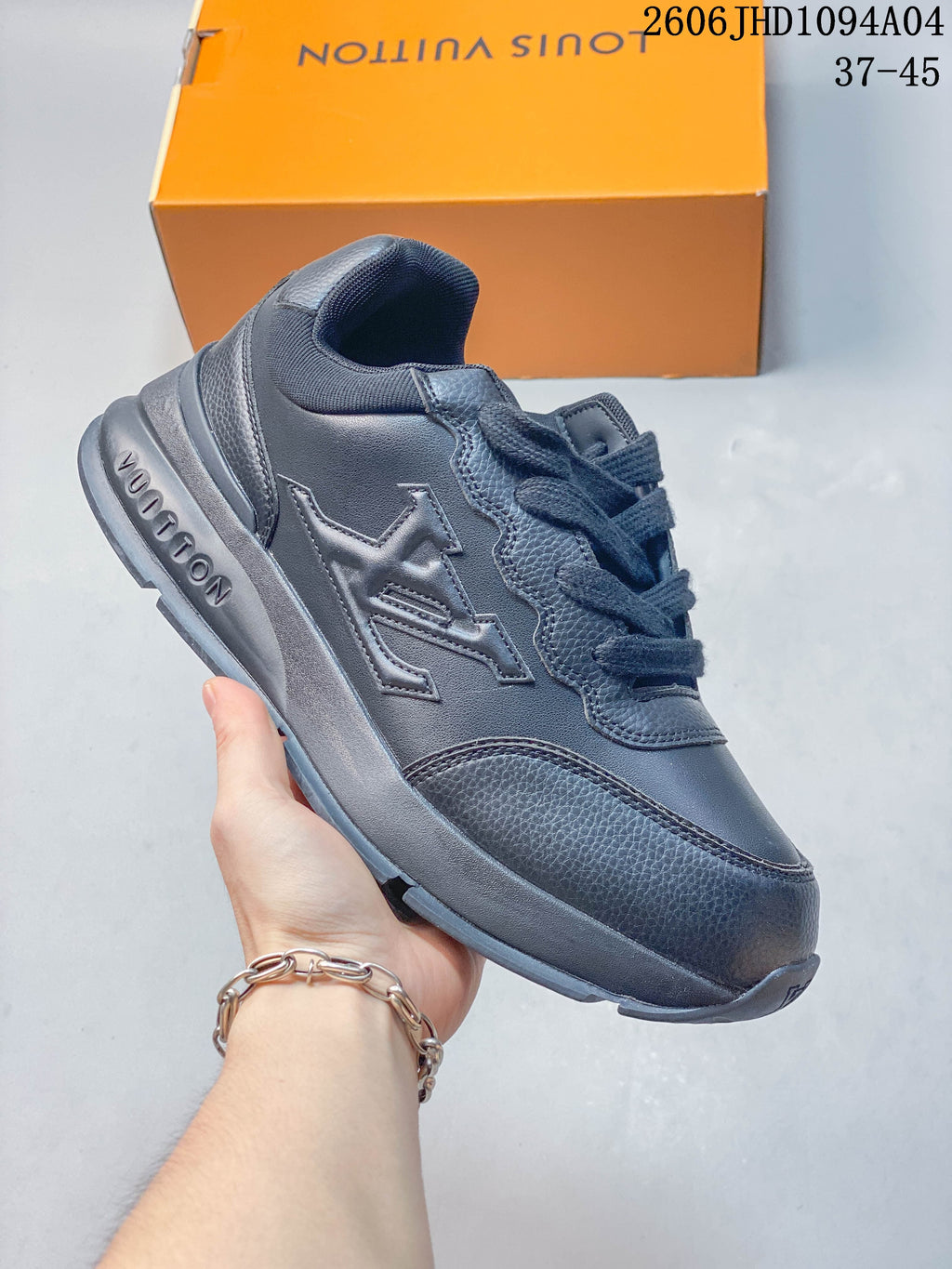 Dark monochrome low-top Louis Vuitton Trainer sneaker with layered panels